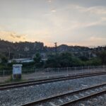 railroad and an old rail station next to some pretty cliffs